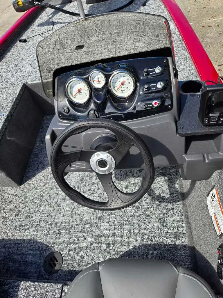 Slide: The Image of 2025 Tracker Pro 170 boat dashboard with steering wheel and gauges. - 7
