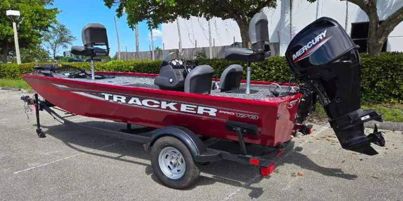 Slide: The Image of 2025 Tracker Pro 170 boat with Mercury engine, parked outdoors. - 8