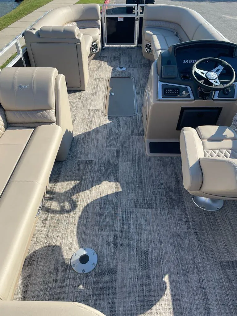 Slide: The Image of 2024 Ranger Reata 223C boat interior with beige seating and modern dashboard. - 4