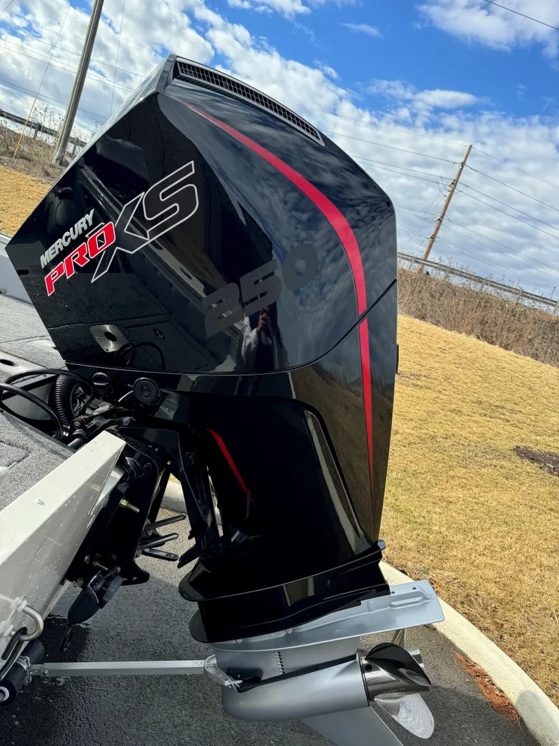 Slide: The Image of 2024 Ranger VX1988 WT with Mercury Pro XS outboard motor, parked outdoors. - 6