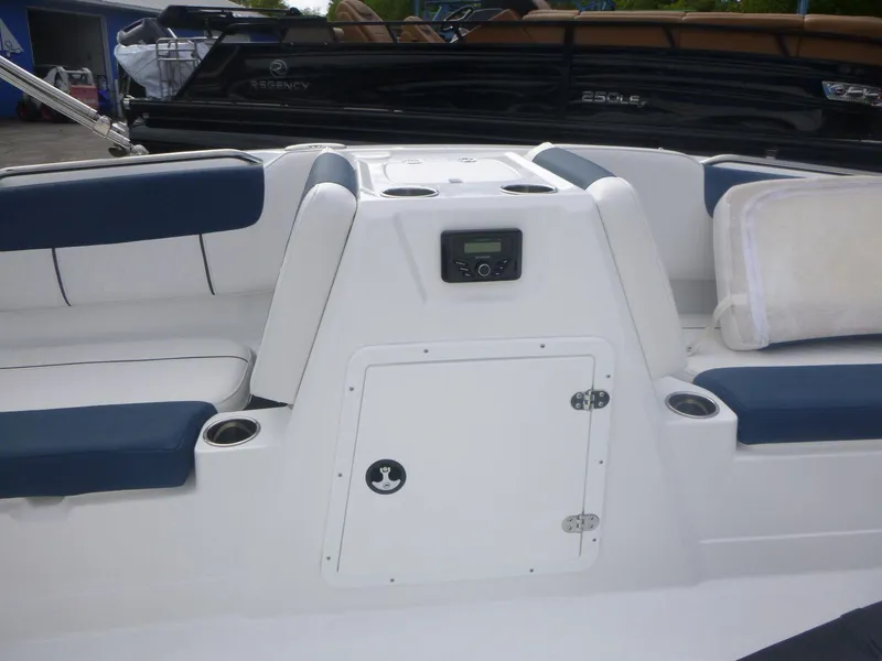 Slide: The Image of 2024 Tahoe 1950 boat interior with blue and white seating and storage compartment. - 16