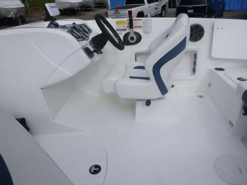 Slide: The Image of 2024 Tahoe 1950 boat interior with steering wheel and seating. - 17