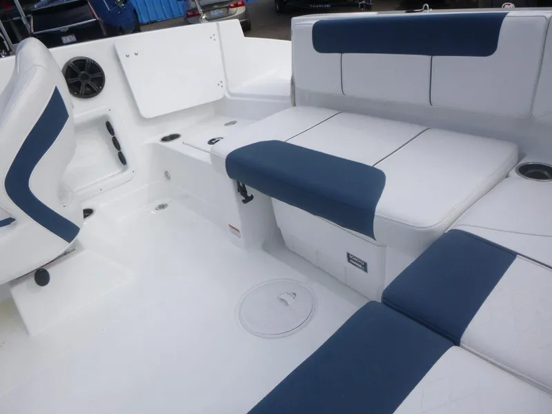 Slide: The Image of 2024 Tahoe 1950 boat interior with blue and white seating. - 18