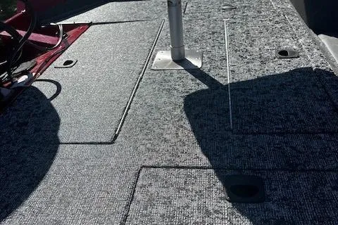 Slide: The Image of 2025 Tracker Pro Team 175 boat deck with textured surface and storage compartments. - 3