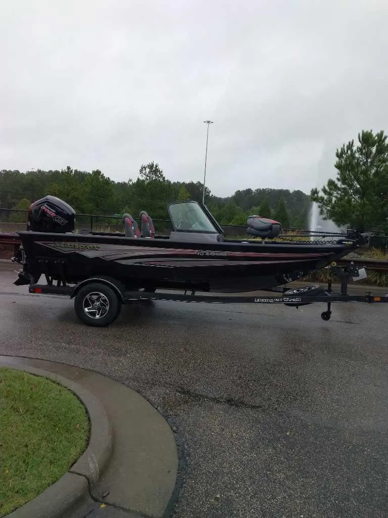 Slide: The Image of 2024 Ranger VS1682SC Angler boat on trailer, parked on wet pavement. - 4