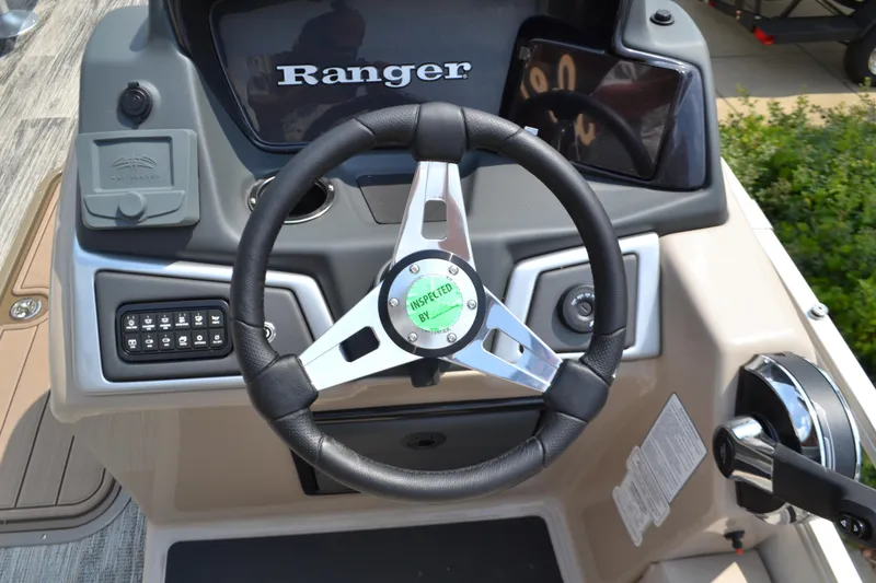 Slide: The Image of 2024 Ranger Reata 223FC boat steering console with controls and dashboard. - 3