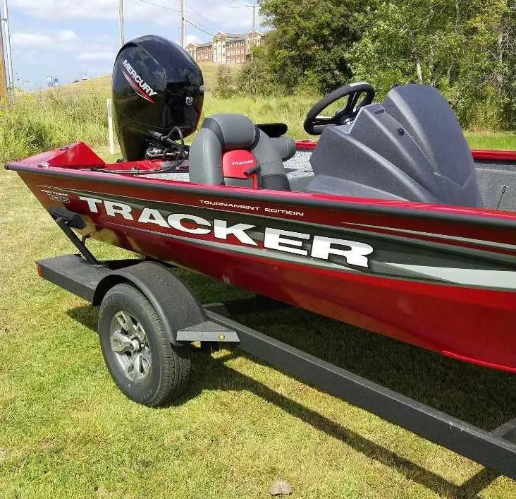 Slide: The Image of 2025 Tracker Pro Team 195 Tournament Edition boat on trailer, red and black design. - 2