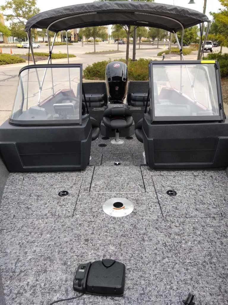 Slide: The Image of 2025 Tracker Pro Guide V-175 Combo boat with spacious deck and dual windshields. - 2