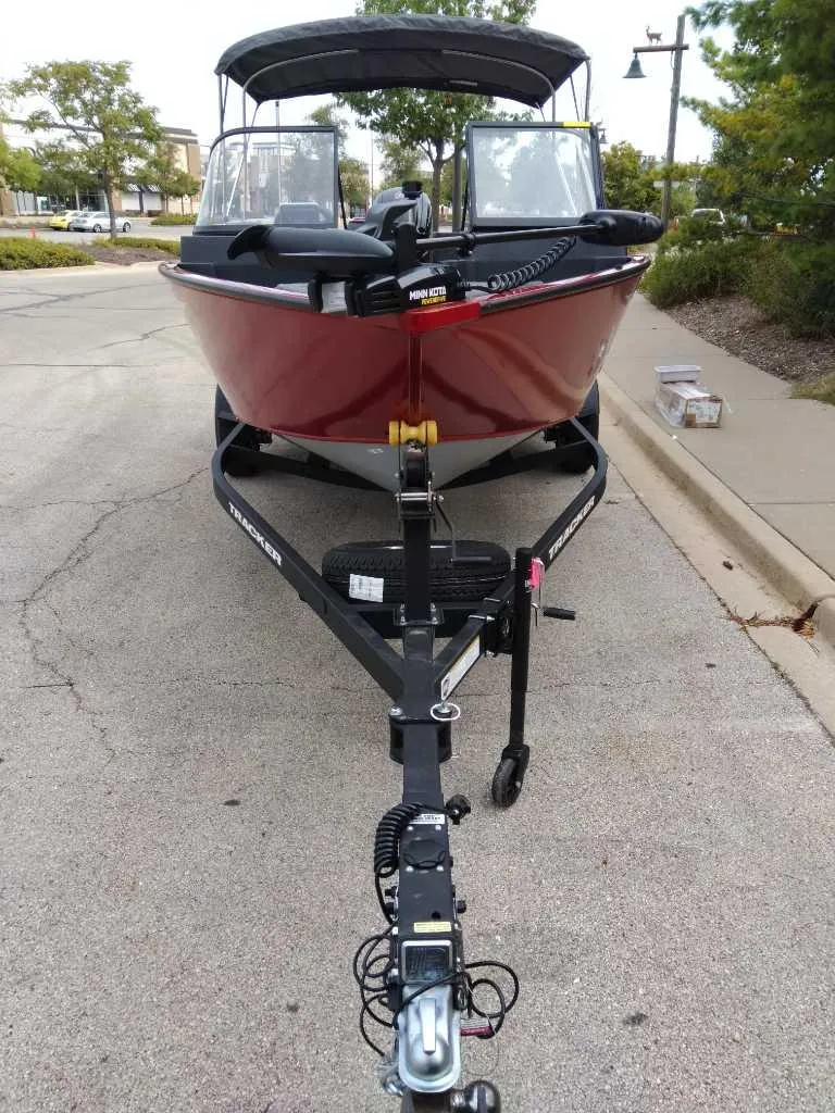 Slide: The Image of 2025 Tracker Pro Guide V-175 Combo boat on trailer, parked outdoors. - 3