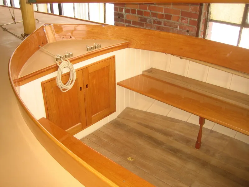 Slide: The Image of Interior of 2008 Herreshoff Full-Keel Buzzards Bay 15 sailboat with wooden finish. - 17