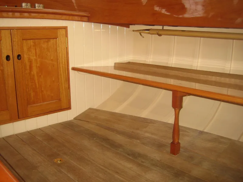 Slide: The Image of Interior of 2008 Herreshoff Full-Keel Buzzards Bay 15 with wooden cabinetry and flooring. - 18