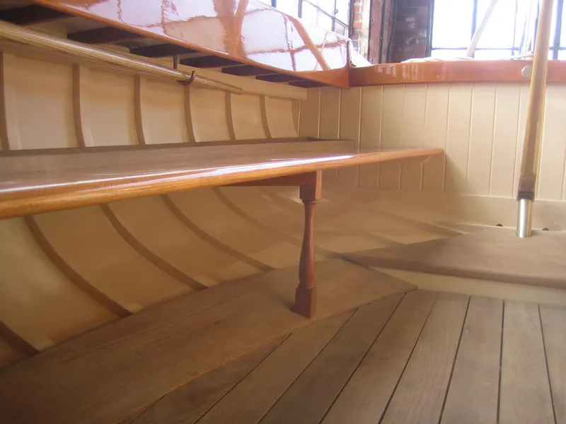 Slide: The Image of Interior of 2008 Herreshoff Full-Keel Buzzards Bay 15, showcasing wooden craftsmanship and seating. - 21