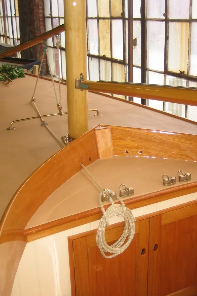 Slide: The Image of 2008 Herreshoff Full-Keel Buzzards Bay 15 sailboat interior with wooden finish and rigging. - 22