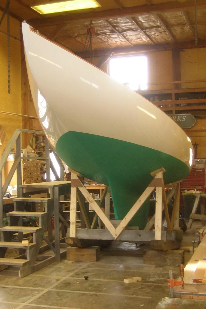 Slide: The Image of 2008 Herreshoff Full-Keel Buzzards Bay 15 sailboat in workshop, green hull, under construction. - 9