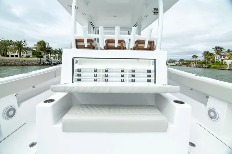 Slide: The Image of 2025 Front Runner 37 Catamaran interior with seating and storage, on a calm waterway. - 11
