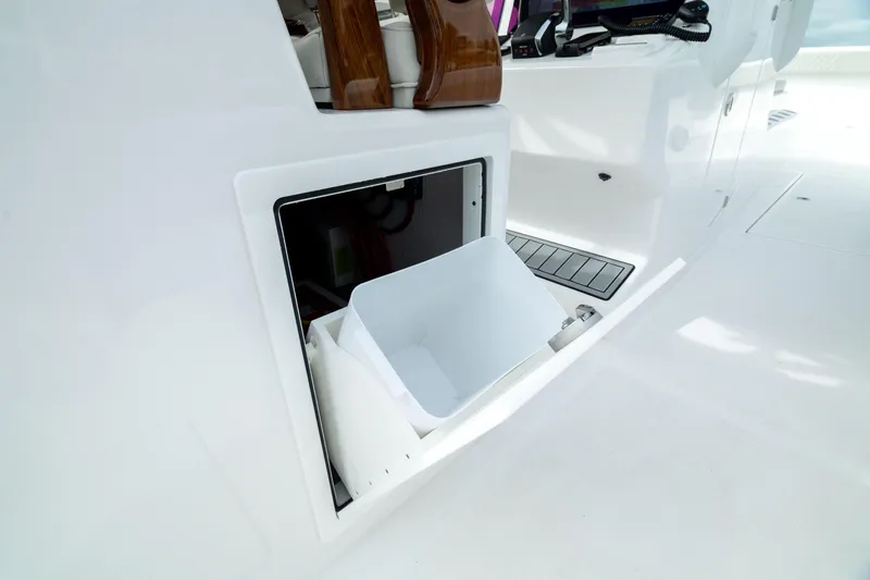 Slide: The Image of Storage compartment on 2025 Front Runner 37 Catamaran, featuring a white bin. - 15
