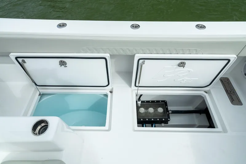 Slide: The Image of 2025 Front Runner 37 Catamaran storage compartments on deck, open to reveal interior features. - 17
