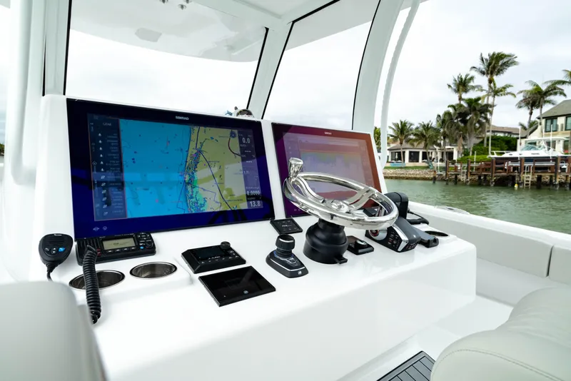 Slide: The Image of 2025 Front Runner 37 Catamaran helm with dual navigation screens and controls. - 2