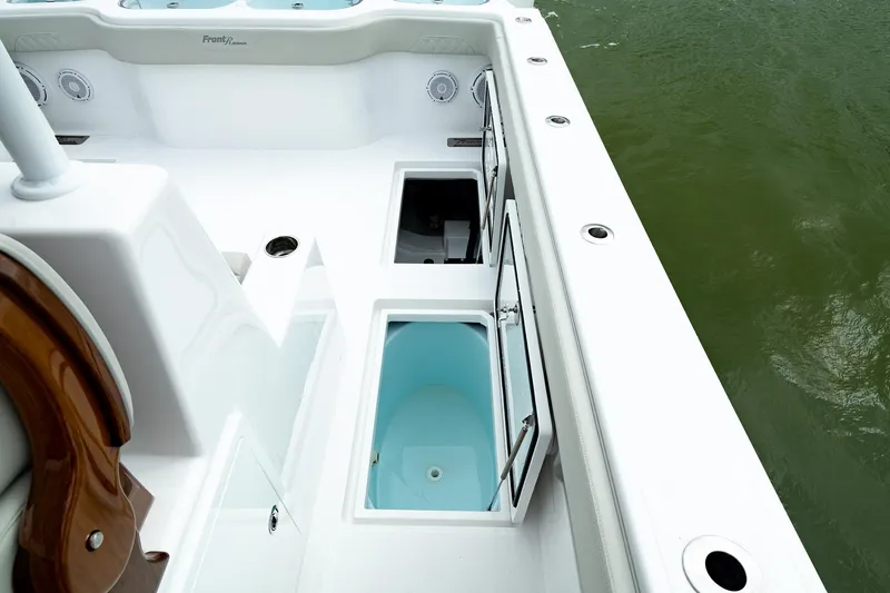 Slide: The Image of 2025 Front Runner 37 Catamaran deck with storage compartments and water view. - 22