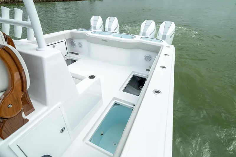 Slide: The Image of 2025 Front Runner 37 Catamaran with spacious deck and multiple outboard engines. - 23