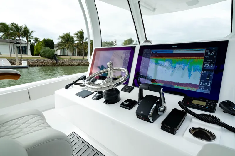 Slide: The Image of 2025 Front Runner 37 Catamaran helm with advanced navigation displays and controls. - 27