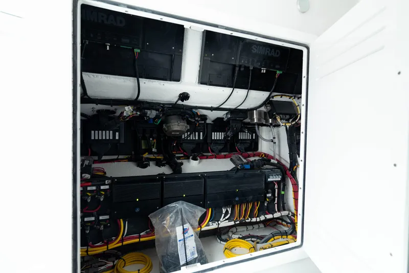 Slide: The Image of Electrical system inside 2025 Front Runner 37 Catamaran, featuring Simrad equipment and organized wiring. - 35