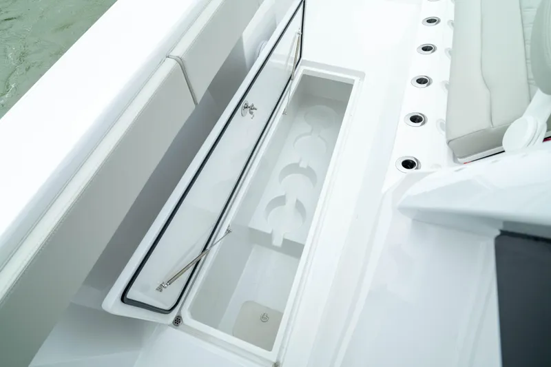 Slide: The Image of 2025 Front Runner 37 Catamaran storage compartment with seating and rod holders. - 38