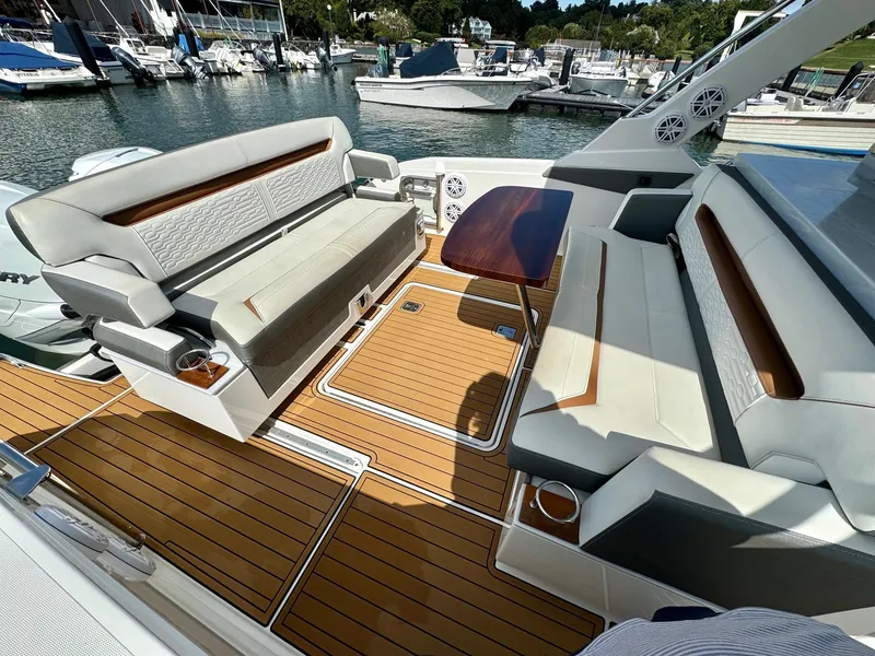 Slide: The Image of Luxurious 2020 Tiara Sport 34 LS boat interior with elegant seating and wooden flooring. - 11