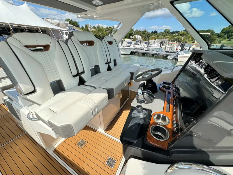 Slide: The Image of Luxurious 2020 Tiara Sport 34 LS yacht interior with plush seating and sleek dashboard. - 15