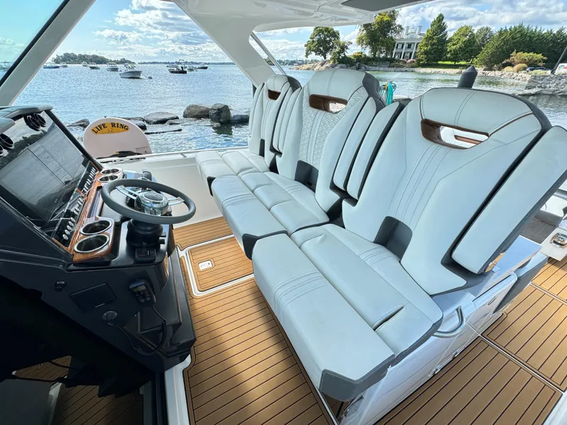 Slide: The Image of 2020 Tiara Sport 34 LS boat interior with luxurious seating and scenic waterfront view. - 16
