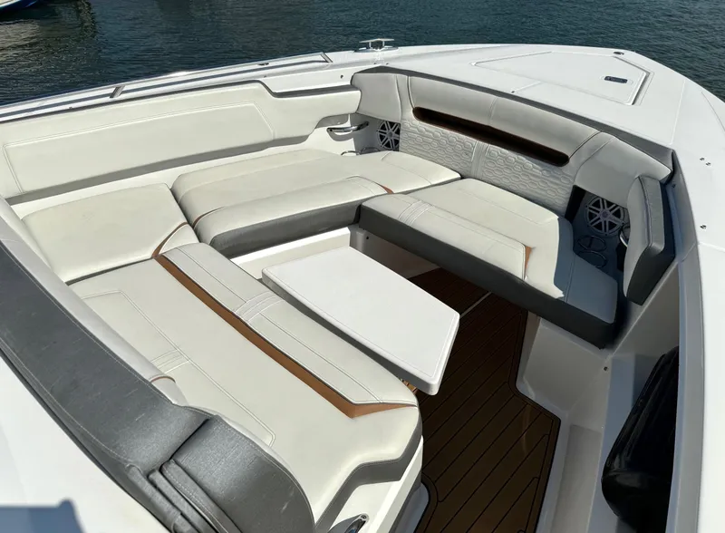 Slide: The Image of 2020 Tiara Sport 34 LS boat interior with luxurious seating and table. - 18