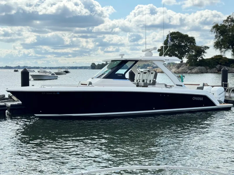 Slide: The Image of 2020 Tiara Sport 34 LS boat docked on a calm lake. - 7