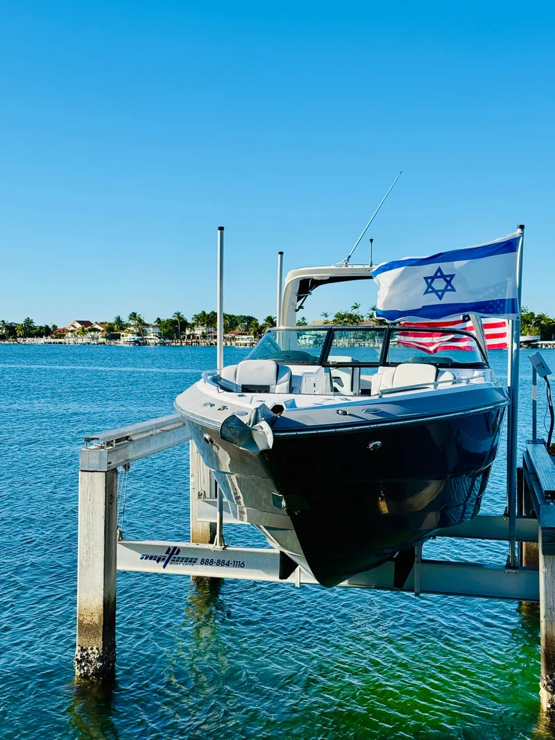 Slide: The Image of 2020 Monterey 328 SS boat docked with Israeli and American flags. - 1