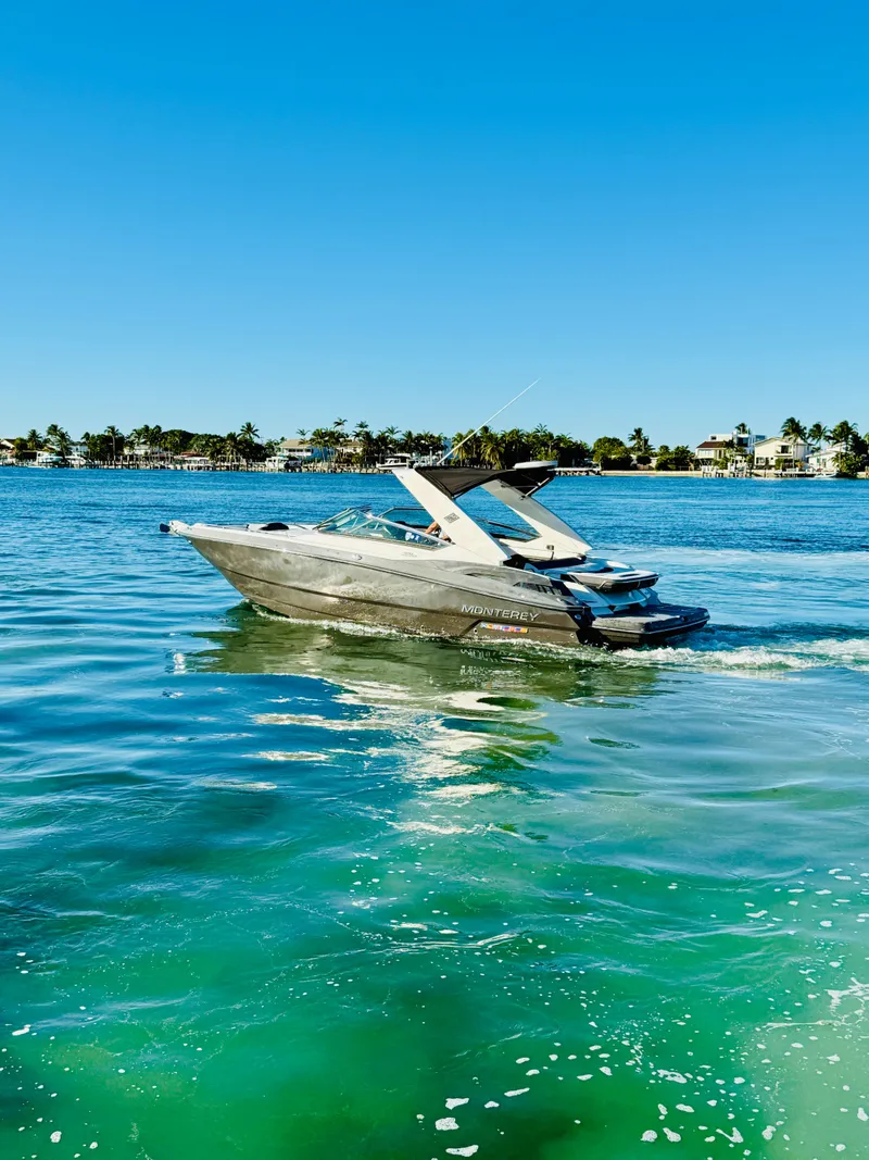 Slide: The Image of 2020 Monterey 328 SS boat cruising on clear blue water under a sunny sky. - 10