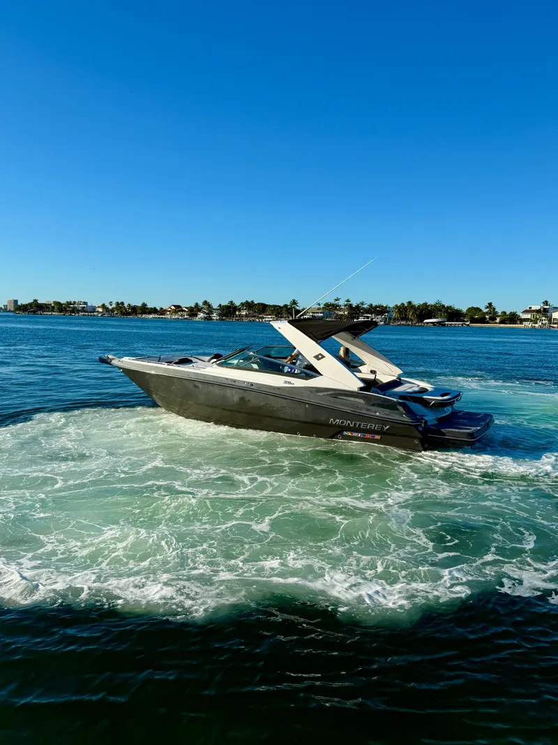 Slide: The Image of 2020 Monterey 328 SS boat cruising on clear blue water. - 11
