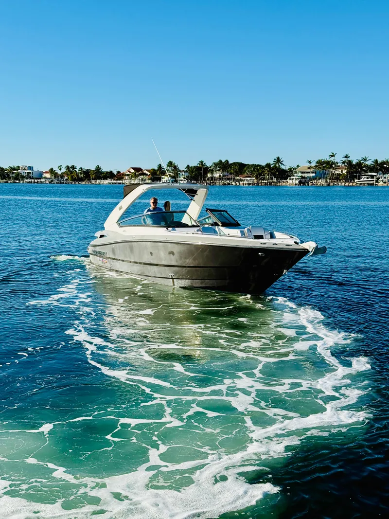 Slide: The Image of 2020 Monterey 328 SS boat cruising on clear blue water. - 12