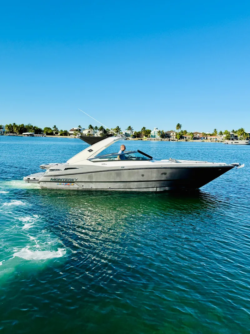 Slide: The Image of 2020 Monterey 328 SS boat cruising on a sunny lake. - 16