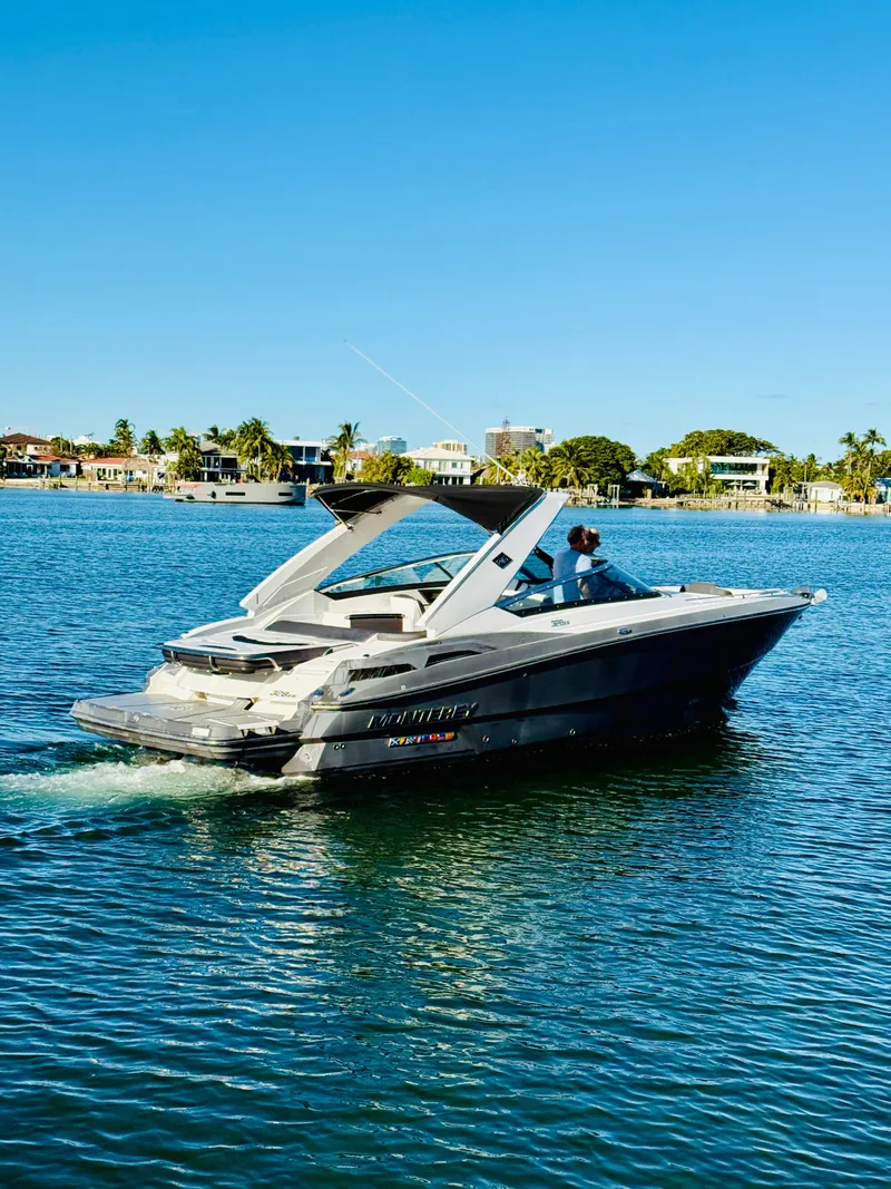 Slide: The Image of 2020 Monterey 328 SS boat cruising on a sunny lake. - 19
