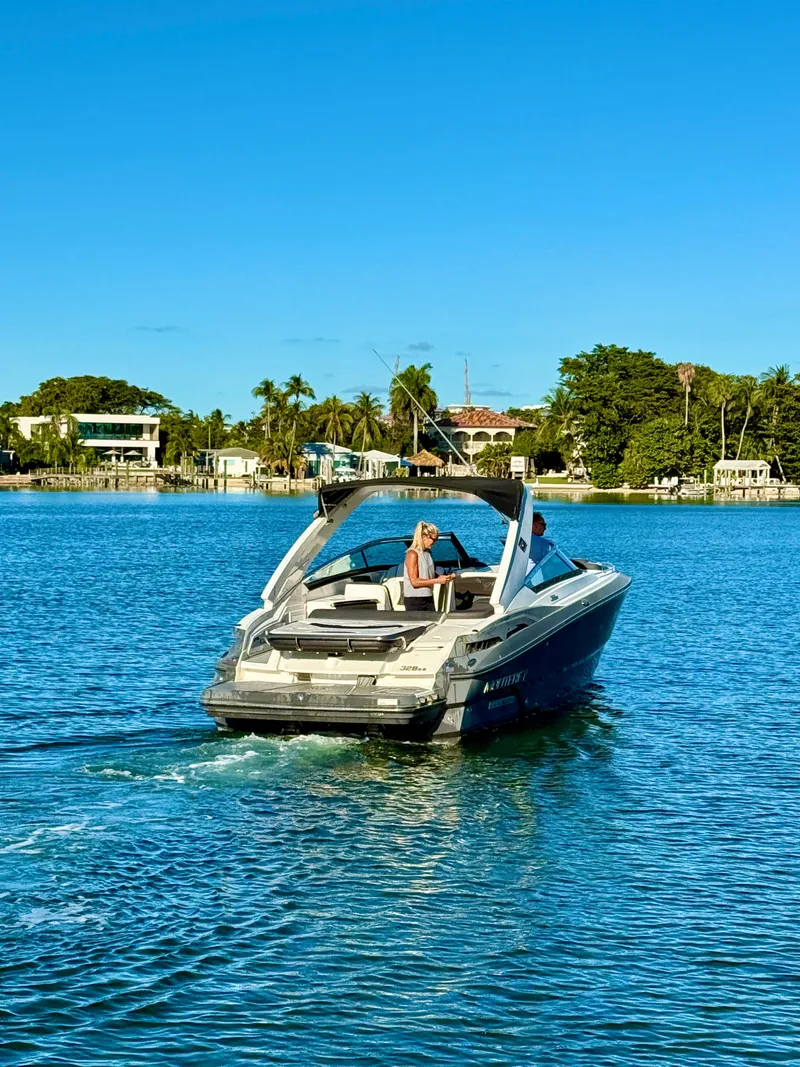 Slide: The Image of 2020 Monterey 328 SS boat cruising on a sunny lake with scenic background. - 20