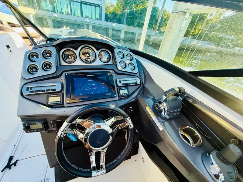 Slide: The Image of 2020 Monterey 328 SS boat dashboard with modern controls and steering wheel. - 25