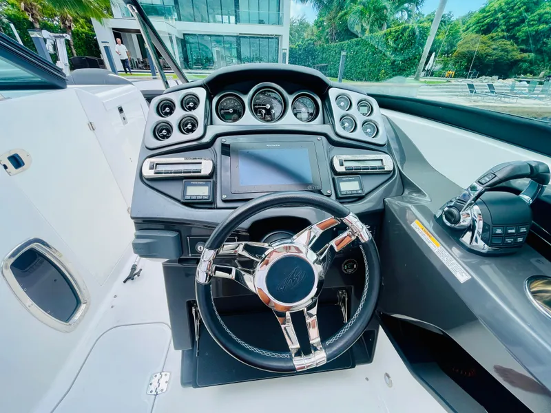 Slide: The Image of 2020 Monterey 328 SS boat dashboard with modern controls and steering wheel. - 26