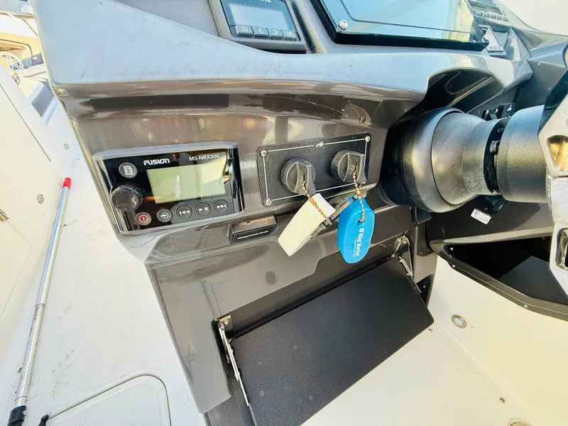 Slide: The Image of Dashboard of a 2020 Monterey 328 SS boat with ignition keys and controls. - 27