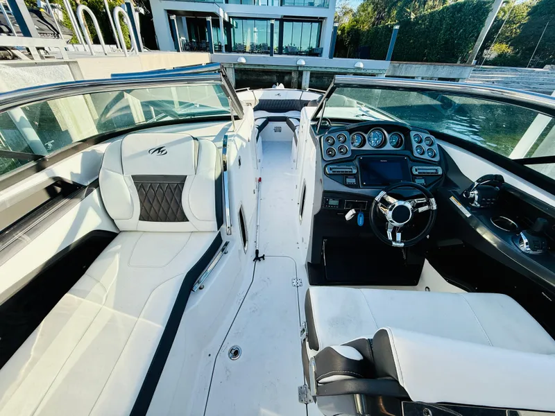 Slide: The Image of 2020 Monterey 328 SS boat interior with luxurious seating and modern dashboard. - 29