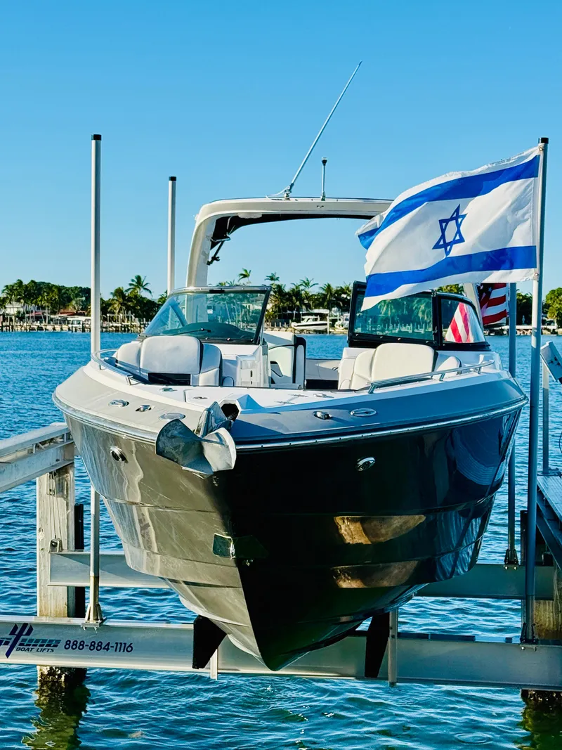 Slide: The Image of 2020 Monterey 328 SS boat docked with Israeli flag, sunny day. - 3
