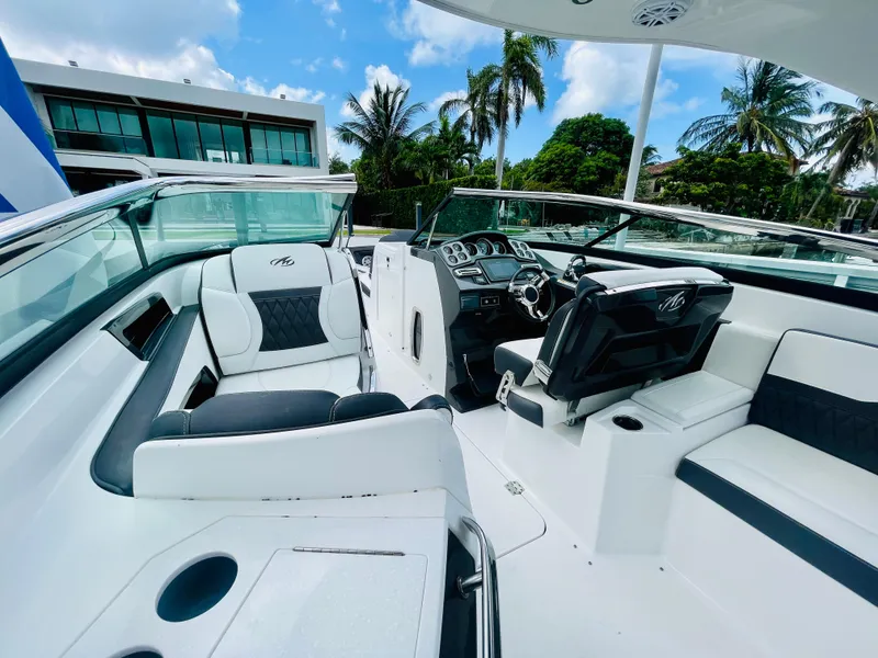 Slide: The Image of 2020 Monterey 328 SS boat interior with luxurious seating and modern dashboard. - 30