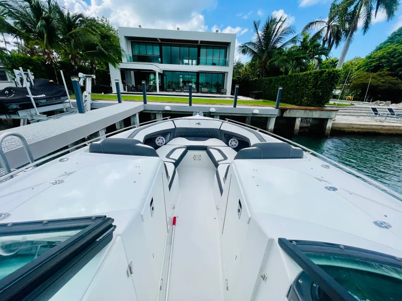 Slide: The Image of 2020 Monterey 328 SS boat docked near modern waterfront home. - 32