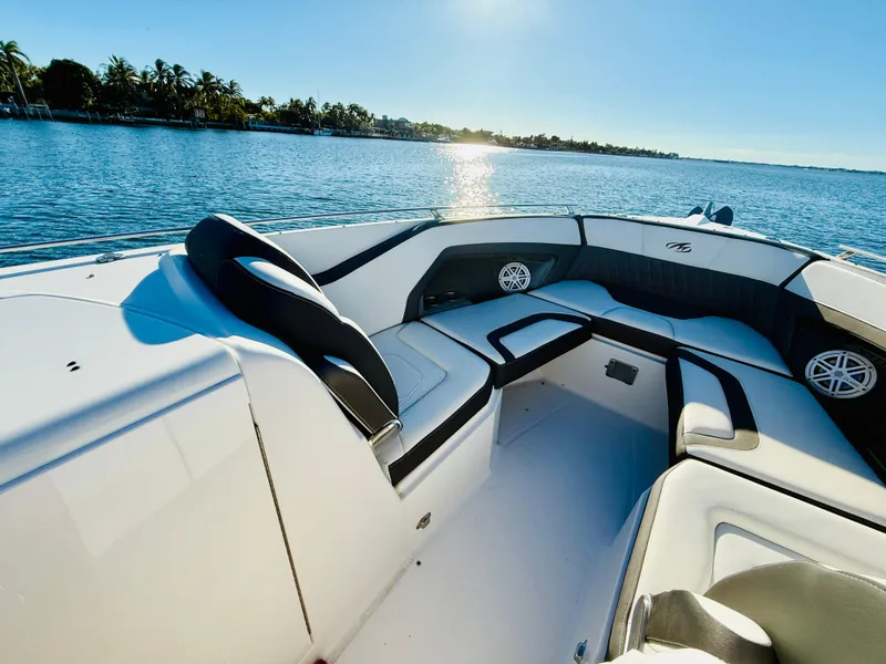 Slide: The Image of 2020 Monterey 328 SS boat interior with luxurious seating on a sunny day by the water. - 34