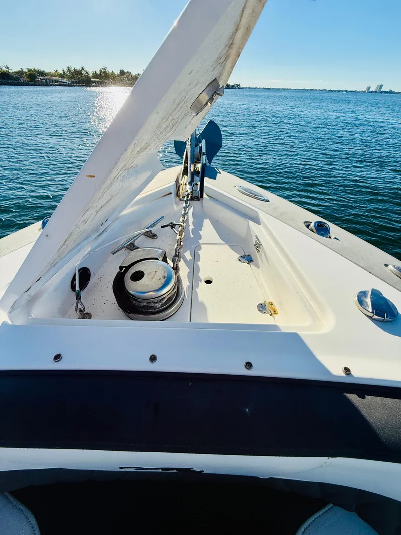 Slide: The Image of 2020 Monterey 328 SS boat on water, open hatch, sunny day. - 37
