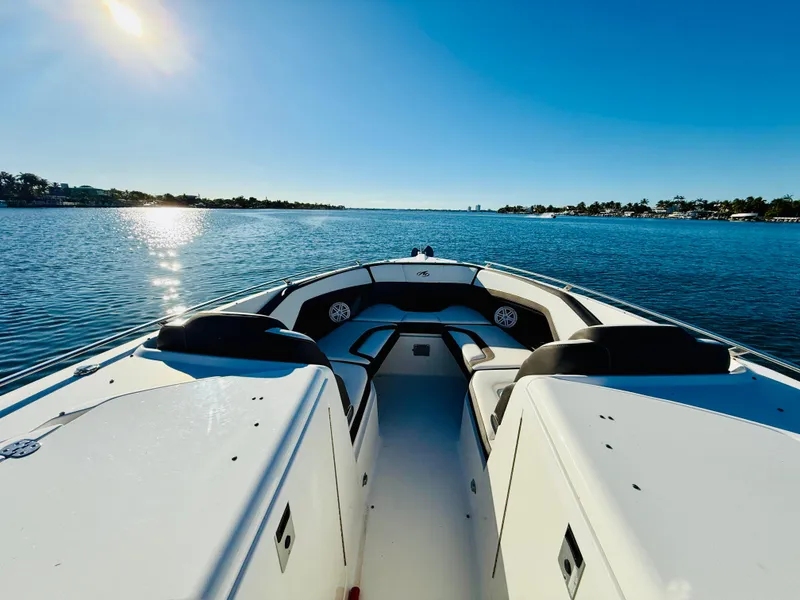 Slide: The Image of 2020 Monterey 328 SS boat on serene water under clear blue sky. - 38