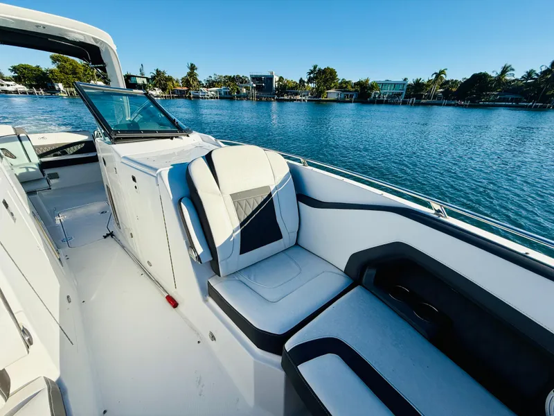 Slide: The Image of 2020 Monterey 328 SS boat interior with luxurious seating by the water. - 41